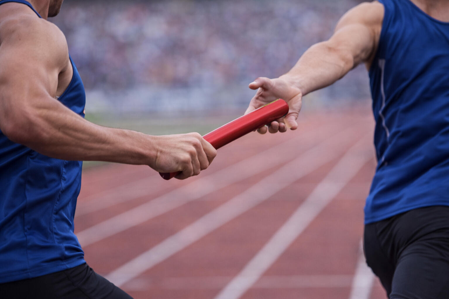 Stepping into a leadership gap immediately Relay race baton handoff symbolizing stepping into leadership responsibility during a transition period